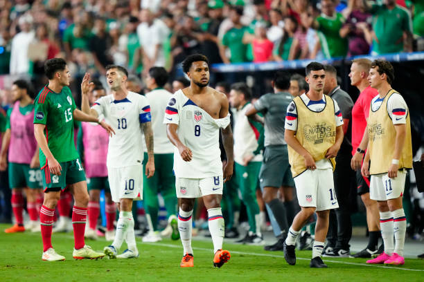 USMNT plauer Weston McKennie is seen walking away with shirt ripped after fight with Mexican team